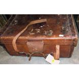 An antique leather suitcase by Erskine with a quantity of textiles