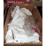 A box of linen and lace textiles with lady's kid gloves