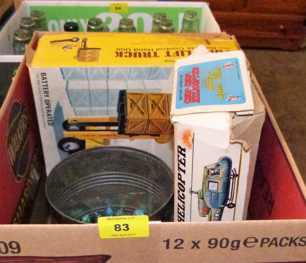 Two 1960's battery operated toys in original boxes, tin of marbles and Airfix soldiers