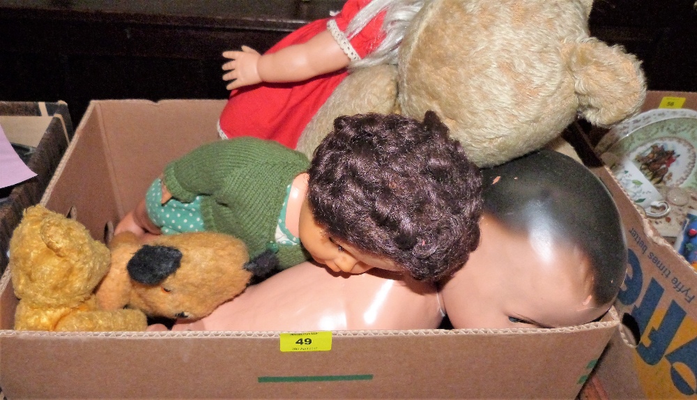 A box of teddy bears and dolls