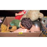 A box of teddy bears and dolls