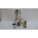 A 19th century Staffordshire spaniel, spill vase and figure