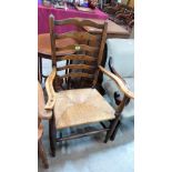 A 19th century Lancashire ladderback elbow chair with rush seat