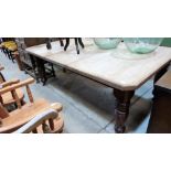 A Victorian dining table on turned legs. Extends to 76'' with one extra leaf