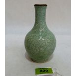 A Chinese celadon glazed bottle vase, with under glazed carved foliate decoration. 5½'' high