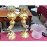 A pair of 19th century brass and horn oil lamps with frosted glass etched shades. 24'' high.