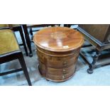 An Asian rosewood and brass inlaid drum table, fitted with twelve locking drawers under the hinged