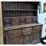 A joined oak Welsh dresser of recent manufacture, the rack with arrangement of drawers and cupboards