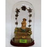A Victorian wax diorama of a girl in a garden setting under a glass dome. 9½'' high