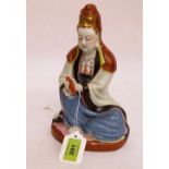 A Chinese figure of the Buddha holding a scroll. 9'' high. Head and shoulders re-stuck