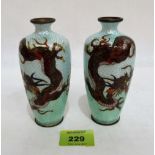 A pair of Japanese cloisonné enamel oviform vases decorated with dragons on a scaly turquoise