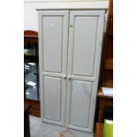 A painted pine wardrobe enclosed by a pair of panel doors. 32'' wide