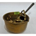 A brass saucepan with iron handle and other brass objects