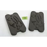 A pair of slate panels moulded with figures in relief. 7¾'' high