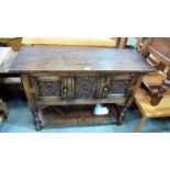 A joined oak 17th century style low dresser of recent manufacture, with geometrically carved doors