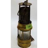 A brass miner's safety lamp by Richard Johnson, Clapham & Morris Limited, Manchester and