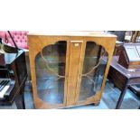 A 1940's walnut china display cabinet. 41'' wide