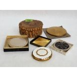 Five powder compacts and a French treen box scratch carved with a deer. Splits