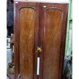 A Victorian mahogany wardrobe enclosed by a pair of arch panel doors. 42'' wide