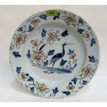 An 18th century Delftware tin glazed charger decorated in shades of blue and manganese with a