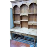 A pine dresser, the raised back with two drawers, over base with frieze drawer on turned legs.