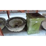 A pair of stone garden urns on pedestal bases