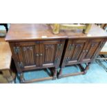 A pair of oak bedside cabinets enclosed by linen fold moulded doors