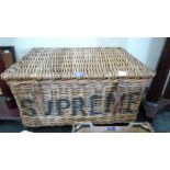 A wicker laundry basket. 29'' wide