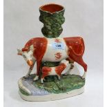 A 19th century Staffordshire cow and calf group spill vase. 10¾'' high. Losses, restorations