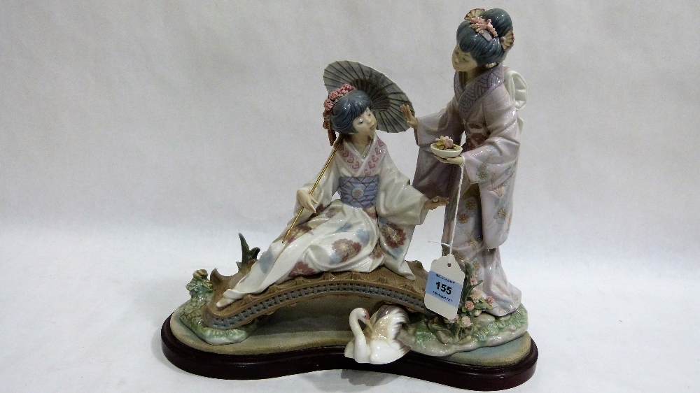 Lladro: A large and impressive group of oriental ladies on a bridge, one with a parasol, raised on a