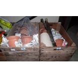 Two crates of terracotta garden pots