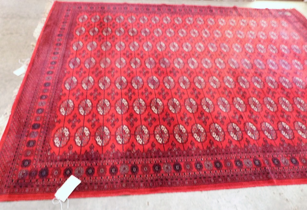 A red ground keshan style carpet. 140'' x 107''