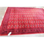 A red ground keshan style carpet. 140'' x 107''