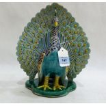 A ceramic model of a peacock, brightly painted in coloured enamels and gilded. 11½'' high