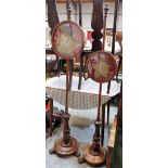 A pair of early Victorian mahogany pole screens with tapestry foliate banners