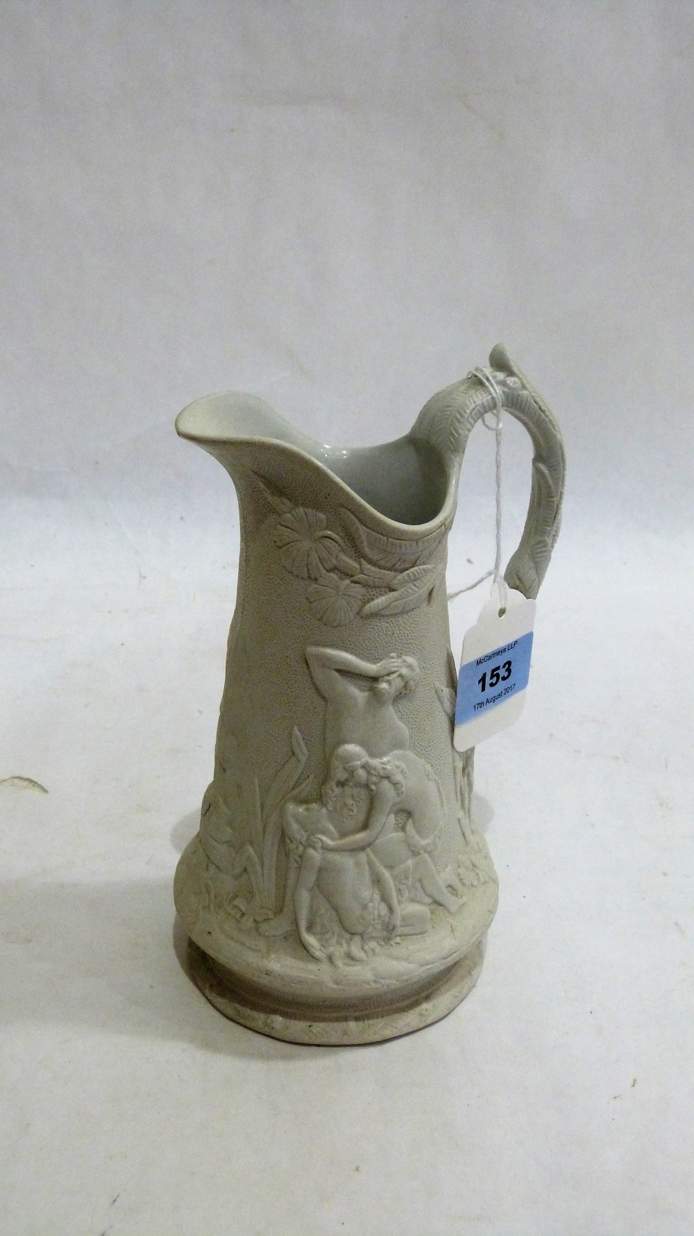 A Victorian salt glazed jug with classical relief decoration in the style of Charles Meigh. 8''