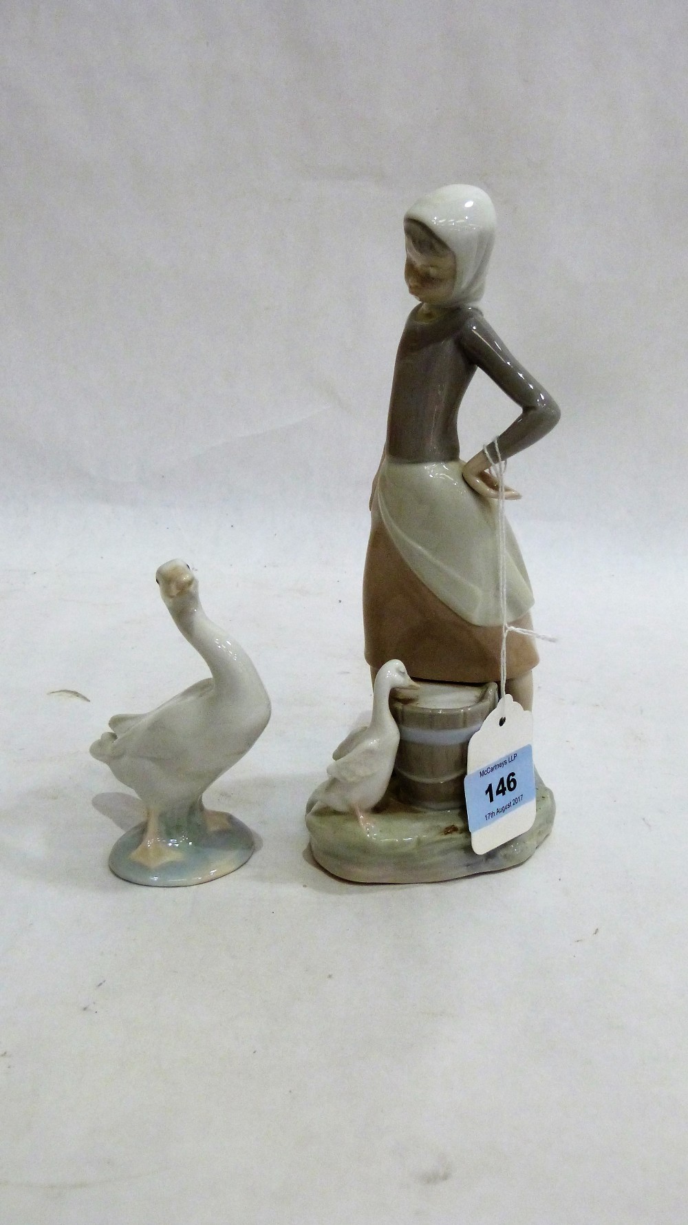 Lladro: Figure of a milkmaid with goose 9¼'' high; together with a figure of a goose 4½'' high