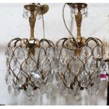 A pair of Italian brass chandeliers hung with prismatic pendant drops. 22'' high