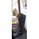 A composition stick stand in the form of a pair of boots, the lot to include two walking sticks