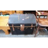 A canvas dome-top cabin trunk