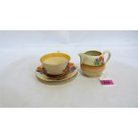 A Clarice Cliff cup, saucer and jug