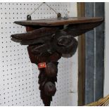 A walnut wall bracket carved with an eagle. 17'' high