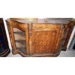 A Victorian walnut, gilt metal mounted and inlaid side cabinet enclosed by a centre door and flanked