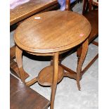 An oak two tier centre table; a demi-lune hall table; an oak occasional table; a cane table; a