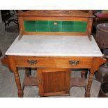 An Edward VII marble topped satinwood washstand with tiled splashback. 36'' wide