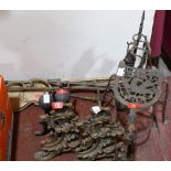 A pair of brass rococo fire dogs, a trivet and other fireside metalware