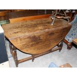 An 18th century joined oak gate leg table with frieze drawer on baluster supports. 51'' wide