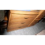 A modern three drawer chest and a pair of matching bedside chests