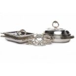 FOUR SILVER PLATED ENTREE DISHES unmarked, of oval form, with scroll decoration and monogrammed EW,
