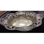 20TH CENTURY SILVER COMPORT of oval form with shaped and pierced cast scroll and floral border,